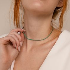 Luck is certain to find you while wearing our Emerald Tennis Choker Necklace. The vivid and brilliant color of the Emerald gemstone is perfect for a statement piece worn alone or to pair with other layering necklaces for a more boho, casual look. No matter which option you choose, you are sure to stand out. Finish/Material: 18K Gold Over Brass ∙ Rhodium Over Brass Featuring ~2mm CZ Emerald Gemstones on an adjustable 14 inch to 16 inch Choker Necklace Part of our Diamond and Pavé Collection Model Everyday Fine Jewelry Green Necklaces, Everyday Fine Jewelry Green Necklace, Green Fine Jewelry Necklace For Everyday, Delicate Chain Emerald Necklace For May Birthstone, Gemstone Beads Jewelry For May Birthstone, Handmade Necklace For May Birthstone, Green Minimalist Choker Jewelry, Trendy Gemstone Bead Jewelry, Trendy Everyday Gemstone Beads Jewelry