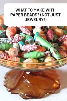 a glass bowl filled with lots of different colored beads