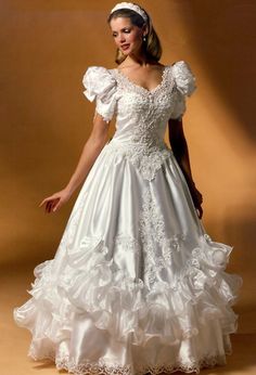 a woman in a wedding dress posing for the camera