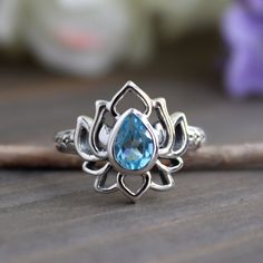 Natural Blue Topaz Lotus Ring-Handmade Lotus Amethyst Silver Ring-Sterling Silver Ring-Silver Lotus Ring-Gift for her- December Birthstone Stone Material:-  Amethyst, Blue Topaz Weight (Approx.):- 3.90 Gram Length:- 15mm Width:- 3 mm  Height:- 5 mM Stone Size (Approx.):- 7 x 5 mm Pear Total Number of Stones:  1 Stone Setting: Bezel Setting Metal: 925 Sterling Silver Finish: High Polish GN-R-1089 Lotus Ring, December Birthstone, Multi Stone Ring, Multi Stone, Ring Handmade, Bezel Setting, Handmade Ring, Stone Rings, Ring Gift