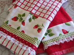 two red and white towels with strawberries on them