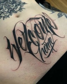 a man's chest with the words welcome home written in cursive writing