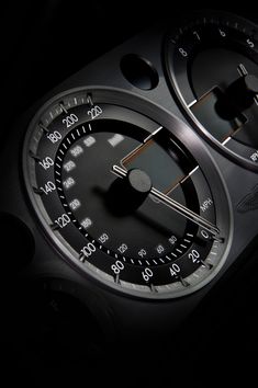 a close up of a speedometer in the dark