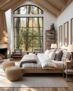 a large bed sitting in the middle of a living room next to a fire place