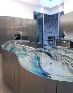 a modern kitchen with an island counter top