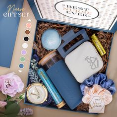 an open gift box filled with personal care items and flowers on top of a table