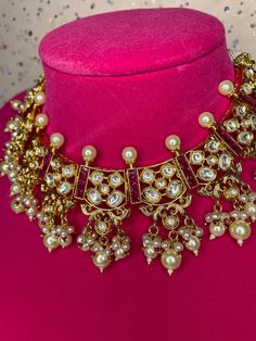 This beautiful traditional modern jadau choker comes with gorgeous matching earrings and is handcrafted with kundan work. The pearl hangings and spiked pears add a touch of elegance to this piece. Great for any event as it‰۪s in a color that can go with any outfit! Party Pearl Drop Chandbali Necklaces, Kundan Choker Necklace For Celebration, Festive Kundan Chandbali Pearl Necklace, Chandbali Kundan Necklace With Pearl Drop, Kundan Chandbali Necklace With Pearl Drop Temple Jewelry, Kundan Necklace With Pearl Drop For Diwali Party, Bollywood Style Kundan Necklace With Pearl Drop For Party, Kundan Chandbali Necklace With Pearl Drop, Kundan Meenakari Temple Necklace For Party