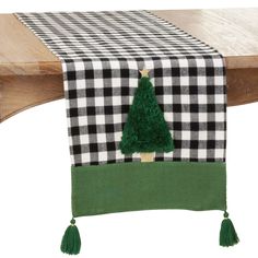 a black and white checkered table runner with a green christmas tree on it