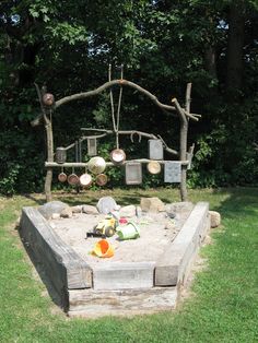 an outdoor sandbox with pots and pans on it