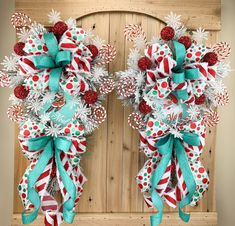 two christmas wreaths with candy canes and snowflakes hanging on a door