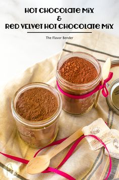 hot chocolate mix and red velvet hot chocolate mix in small jars with spoons next to them