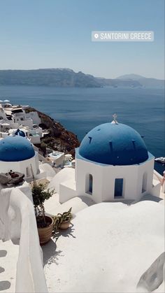 some white and blue buildings with water in the background