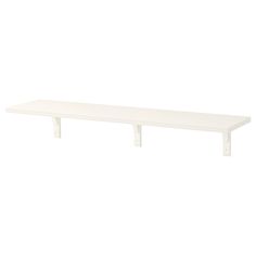 a white shelf sitting on top of a wall