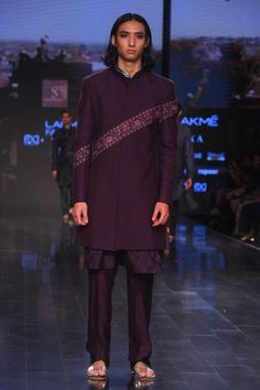 Purple quilted achkan with floral embroidered motifs. Comes with kurta and straight pants.
Component: 3
Pattern: Embroidery
Type Of Work: Thread
Neckline: Band
Sleeve Type: Full
Fabric: Silk
Color: Purple
Other Details: 
Front and side slits
Note: Choker worn by the model is not for sale
Occasion: Wedding - Aza Fashions Kurta Set Men, Kurta Set For Men, Purple Quilts, Nehru Jacket, Nehru Jackets, Purple Silk, Silk Embroidery, Kurta Set, Designer Gowns