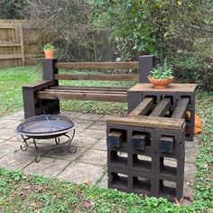 a wooden bench sitting next to a fire pit