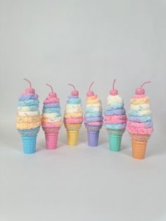 Yarny Yum Cones: Decorative Yarn Ice Cream Cones Add a cozy and whimsical touch to your home décor with our Yarny Yum Cones! These charming and colorful yarn ice cream cones are perfect for adding a sweet, handmade feel to any room or event. Features: *Handcrafted Charm: Our yarn ice cream cones come in a variety of delightful pastel colors, with each scoop carefully crafted from soft, plush yarn. The cones are topped with glittery cherries and sprinkles, adding to their handcrafted appeal. *Featuring a range of vibrant colors like soft pinks, blues, yellows, and purples, these cones have multiple layers of "ice cream" scoops, each adorned with colorful sprinkles and glittery accents. *Perfect for All Seasons: Whether you're decorating for a Sweets Theme Christmas, Summer Parties, Baby Sho Ice Cream Cone Christmas Tree, Candyland Ornaments, Ice Cream Wreath, Wreath Picks, Cream Wreath, Cone Ornaments, Christmas Summer, Candyland Christmas