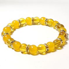 Sunny Days Ahead Glass Beaded Stretch Bracelet 8mm Opaque & Transparent Yellow Glass Beads Yellow Rhinestone Rondelles Handmade By Me 7" Length New If You Want A Different Size Or Color Scheme, Please Let Me Know, I Can Customize For You. Yellow Bead Bracelet Ideas, Yellow Glass Bead Bracelet, Elegant Yellow Beaded Bracelets With Gold Beads, Elegant Yellow Beaded Bracelet With Gold Beads, Yellow Citrine Jewelry With Faceted Beads, Adjustable Yellow Crystal Bracelet With Gemstone Beads, Gold Citrine Beaded Bracelets With Round Beads, Elegant Yellow Stretch Bracelet With Round Beads, Elegant Yellow Crystal Bracelet With Round Beads