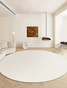 a living room with a large white rug on the floor