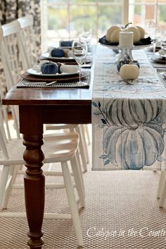 Wood table with white chairs and blue pumpkin table runner Blue And White Decorating Ideas, Blue And White Fall Decor, White Decorating Ideas, White Fall Decor, Fall Table Setting, Halloween Table Settings