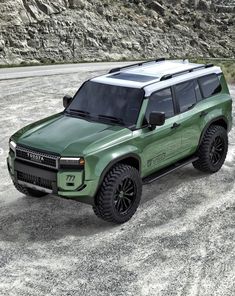 a green suv parked on top of a gravel road