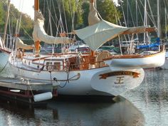 a sailboat docked at a dock in the water