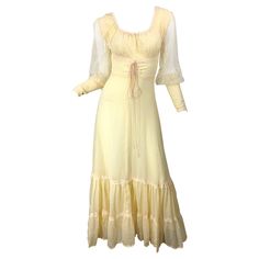 Beautiful 70s Victorian inspired pale yellow cotton voile and lace maxi dress! Features laces up the front. Semi sheer lace sleeves with fitted cotton cuffs that have zippers on each. Hidden metal zipper up the back with hook-and-eye closure. In great condition and very well made. Approximately Size Small Measurements: 34 inch bust 24 inch waist 42 inch hips 58 inches from top back shoulder seam to hem 70s Victorian, 1920s Evening Dress, 1970 Dress, Knit Lace Dress, Green Shift Dress, 70s Maxi Dress, Calf Length Dress, 1980s Dresses, Maxi Gown Dress