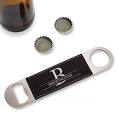 the bottle opener is next to two beer bottles