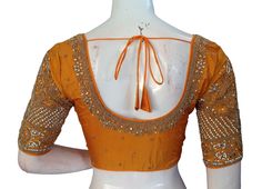 Radiate warmth and joy in this vibrant mustard yellow Aari blouse, inspired by the auspicious Haldi ceremony. Meticulously hand-embroidered on delicate tissue silk, this blouse is a celebration of Indian tradition and artistry. * This Is A Fully Stitched Saree Blouse, Ready To Wear * Made of Semi Silk, Lined With Cotton * Opens From Front With Hook and eye-fitting Size:36,38,40 Sleeve: 11 inches  Blouse Length: 14.5 inches  Neck depth: 7.5 inches Front / 9.5inches Back                 Padded: Ye Stitched Saree, Aari Blouse, Saree Blouses, Indian Blouse, Haldi Ceremony, Indian Ethnic Wear, Blouse Length, Handmade Design, Indian Wear