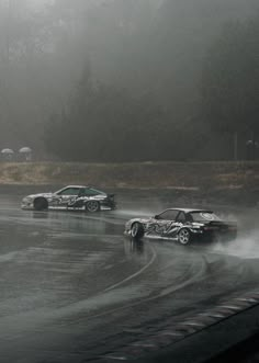 two cars driving on a wet road in the rain