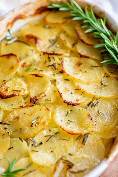 a dish with potatoes and herbs in it