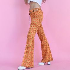 "Vintage 70s flare pants Bright retro psychedelic orange and yellow geometric print and textured flared bell bottom pants  ▫️large belt loops ▫️zipper and button closure  ▫️no front pockets, two pockets on the back Label: Lasso tailored western wear No size or material content, feels like polyester blend Overall excellent vintage condition, no signs of wear! 📀 Measurements 📀 Waist: 28\" Rise: 9.5\" Hips: 36\" Inseam: 31.5\" Material does have a little stretch Model is 5'4\" wears size small, f Trendy Flared Pants With Belt Loops, Retro Flares For Fall, Retro Fall Flares, Retro Style Fall Festival Pants, Retro Flare Bottoms For Fall, Retro Full-length Fall Flares, Retro Full Length Fall Flares, Fitted Retro Print Groovy Bottoms, Fitted Bottoms With Retro Print In Groovy Style