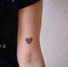 a woman's arm with a fingerprint in the shape of a heart on it