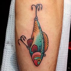 a colorful fish tattoo on the leg