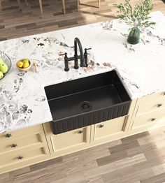 a kitchen sink sitting on top of a counter next to a bowl filled with fruit