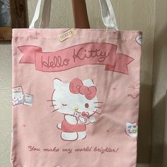 a hello kitty bag hanging from a door