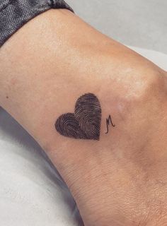 a fingerprint in the shape of a heart on a woman's left foot