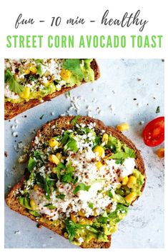 two pieces of bread with corn and avocado on top, next to tomatoes