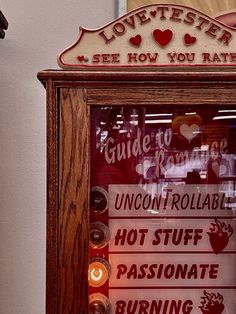 a wooden frame with signs and candles in front of a store window that says lovettters, see how you rate