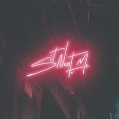 a neon sign that reads sit next to it