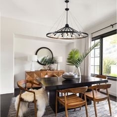 the dining room table is surrounded by wooden chairs and an area rug that matches the carpet