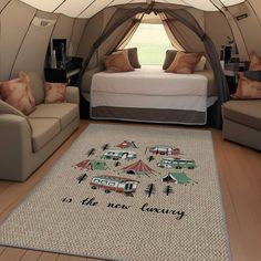 a bedroom with two couches, a bed and a rug in the shape of a tent