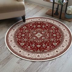 a red and white rug on the floor in a living room