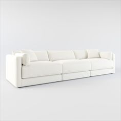 a white couch with pillows on top of it