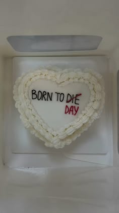 a cake shaped like a heart with the words born to die day written on it