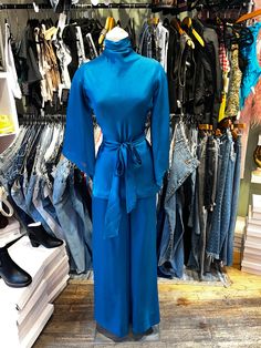 ♥ D E S C R I P T I O N ♥ Vintage 70s 2pc set. Fabric is a beautiful vibrant blue satin. Top is a tunic shape with handkerchiefs style sleeves, draped mock neck collar, and matching tie at the waist. Matching wide leg flare pants.  ♥ S I Z E & M E A S U R E M E N T S ♥ Measurements taken across while garment laying flat and unstretched. Double measurement to get the all around. Measurements- Top- Bust: 17.5 in Waist: 16 in Length: 27 in Bottoms- Waist: 13.5 in Hips: 18.5 in Length: 43 in fits si Chic Rayon Sets For Spring, Spring Long Sleeve Rayon Sets, Chic Silk Sets For Spring, Spring Evening Satin Sets, Satin Evening Sets For Spring, Blue Stretch Sets For Fall, Blue Long Sleeve Satin Sets, Blue Satin Long Sleeve Sets, Silk Long Sleeve Sets For Fall