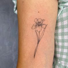 a single flower tattoo on the arm