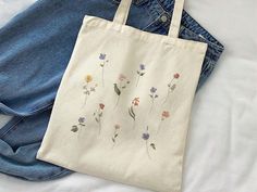 Aesthetic Wild Flowers Canvas Tote Bag, Vintage Flowers Cute Canvas Tote Bag, Gardening Aesthetic Tote Bag, Botanical Flowers Canvas Tote   This 100% cotton bag comes in one size - 15" x 16"- perfect for everyday wear. The bag features 20" handles (made from the same canvas), making it easy to carry even with a week's worth of shopping. - Liberty Bags OAD113 - ⭐ PRODUCT DETAILS ⭐ 💖 100% cotton canvas. 💖 Heavy fabric (12 oz/yd² (406.9 g/m 💖 Sewn-in label ⭐ CARE INSTRUCTIONS ⭐ 💖Machine wash: cold (max 30C or 90F) 💖Non-chlorine: bleach as needed 💖Tumble dry: medium heat 💖Do not iron directly over the printed area - print may stick to the iron. 😊If you have any questions please feel free to ask me😊 Rectangular Bags With Plant Print For Daily Use, White Botanical Style Bag For Spring, Spring Botanical Rectangular Bags, Gardening Aesthetic, Liberty Bag, Flower Tote Bag, Aesthetic Tote Bag, Flowers Cute, Flowers Canvas