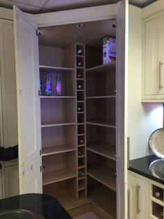 an open pantry with lots of bottles in it