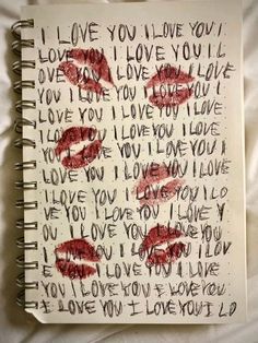 an open notebook with writing on it and two red lips painted on the pages that say i love you