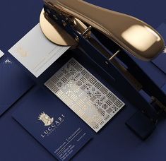 an elegant blue and gold stationery set with matching envelopes, business cards and pen